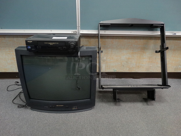 Sharp 27" Television w/ Sharp VHS Player and Mount. (Room 101)