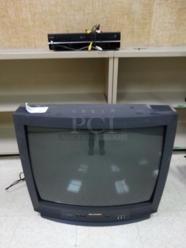 Sharp 27" Television w/ Mount and VHS Player.  (Room 104)