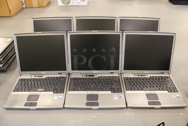 6 Dell Model PP05L D600 14" Laptops w/ 5 Chargers. 6 Times Your Bid! (Basement: Room 019)