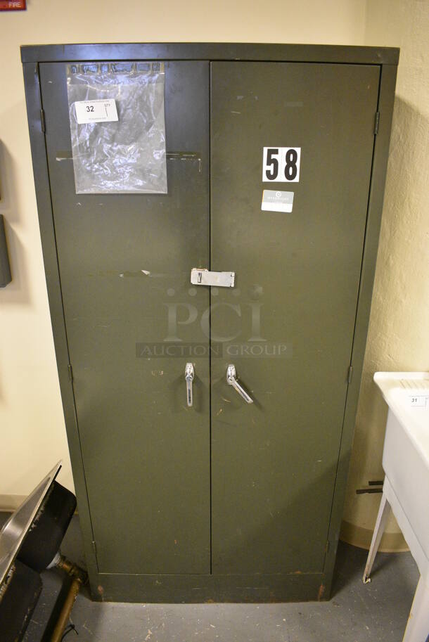 Green Metal 2 Door Cabinet. 35x19x72. (room 102)