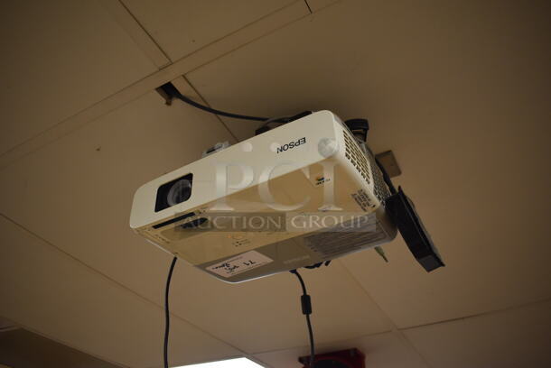 Epson Ceiling Mounted Projector and Pull Down Projection Screen. Stock Picture Used. BUYER MUST REMOVE. 11x8x4, 94". (EMT/Forensics Lab)
