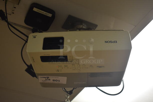 Epson Ceiling Mounted Projector and Pull Down Projection Screen. BUYER MUST REMOVE. 11x8x4, 94". (Education Kitchen)