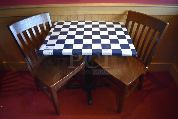 Table w/ Table Cloth on Black Metal Table Base and 2 Wooden Dining Chairs. 30x24x29, 18x16x35. (Party Dining Room)
