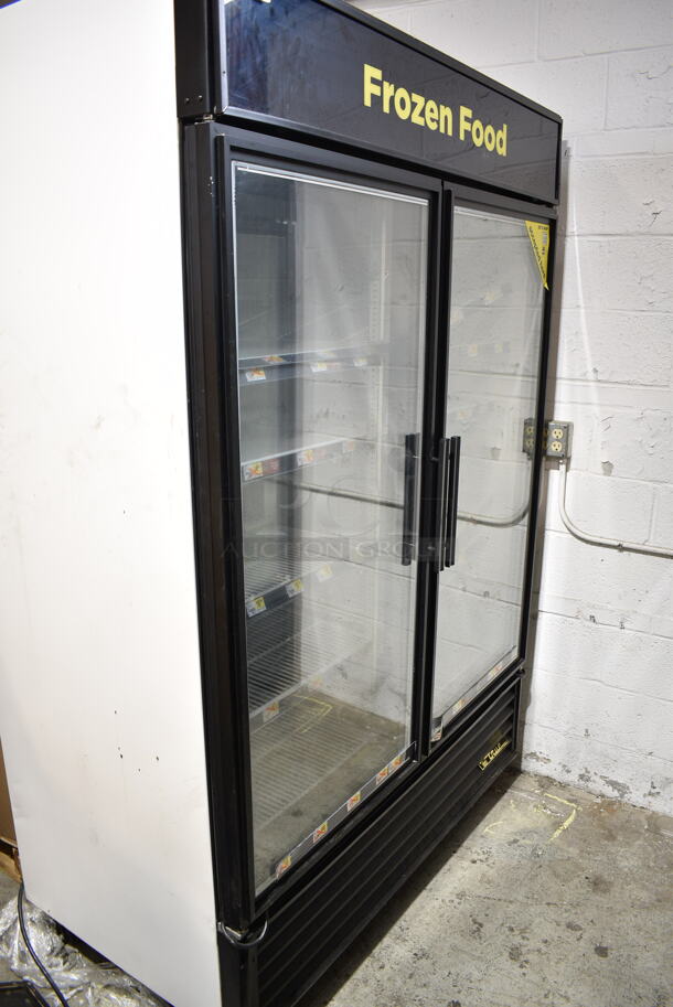 2015 True GDM-49F-LD ENERGY STAR Metal Commercial 2 Door Reach In Freezer Merchandiser w/ Poly Coated Freezer on Commercial Casters. 115/208-230 Volts, 1 Phase. Tested and Working!