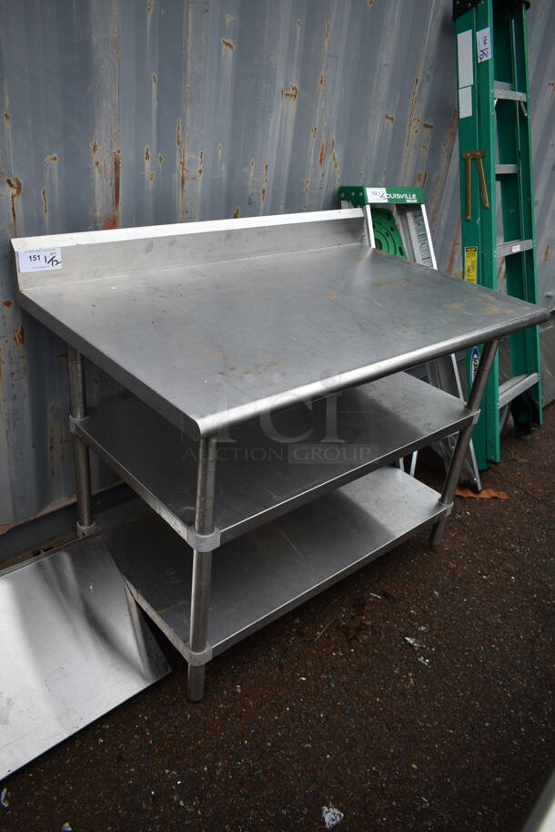 Stainless Steel Commercial Table w/ Back Splash and 2 Under Shelves.