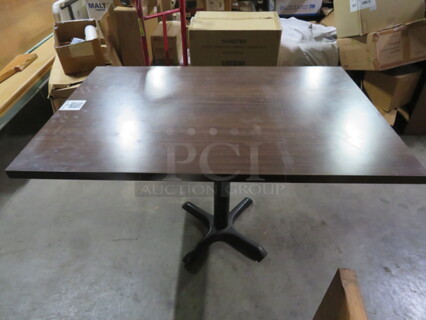 One Brown Laminate Table Top On A Pedestal Base. 30X45X29