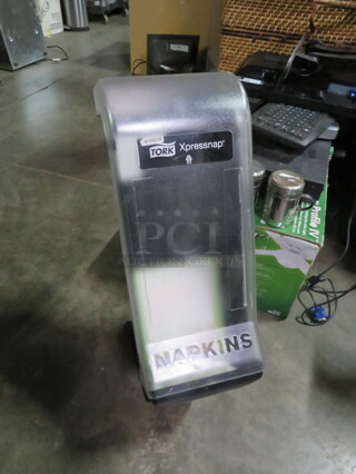 One Tork Xpressnap Napkin Dispenser. 