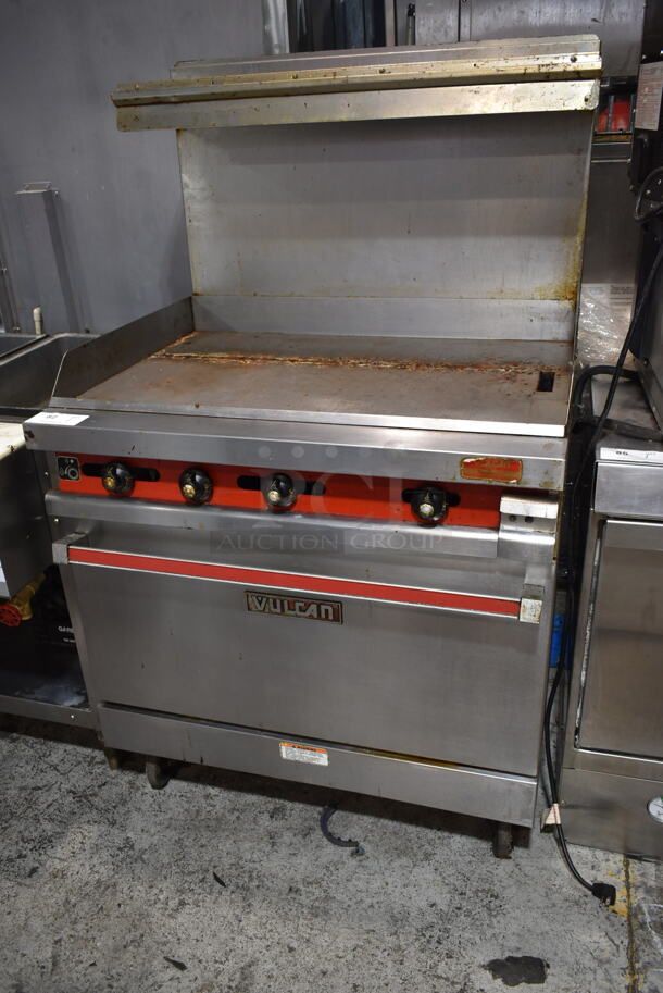 Vulcan 36XTL-559 Stainless Steel Commercial Propane Gas Powered Flat Top Griddle w/ Oven, Over Shelf and Back Splash on Commercial Casters. - Item #1116894