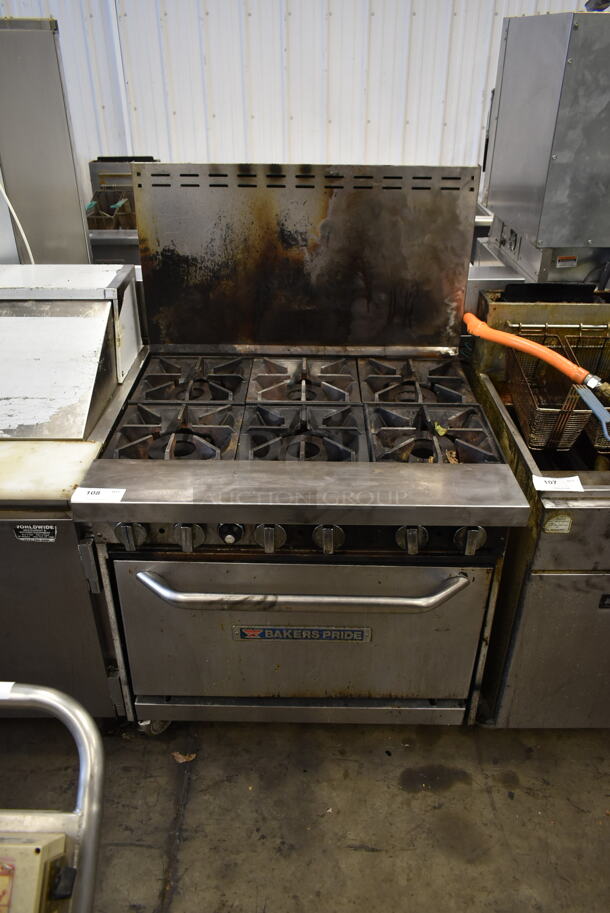 Bakers Pride Stainless Steel Commercial Natural Gas Powered 6 Burner Range w/ Oven and Back Splash on Commercial Casters.