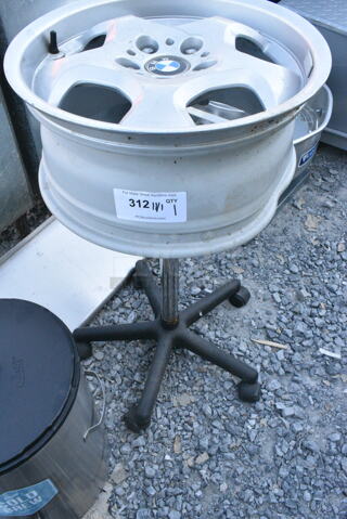 BMW Rim on Stand w/ Casters. Was Used as a Table w/ Glass Pane on Top That Does Not Come w/ The Unit