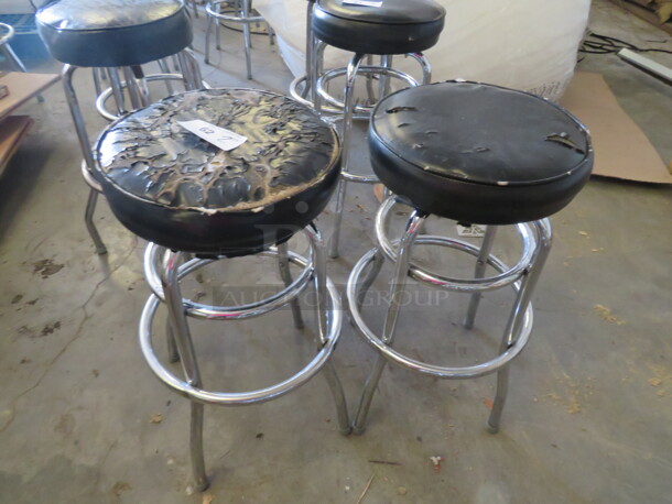 Chrome Bar Stool With A Footrest, And A Black Cushioned Swivel Seat. 2XBID