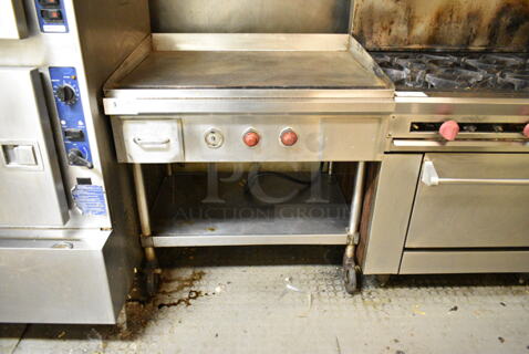 Stainless Steel Commercial Electric Powered Flat Top Griddle w/ Under Shelf on Commercial Casters. (kitchen)