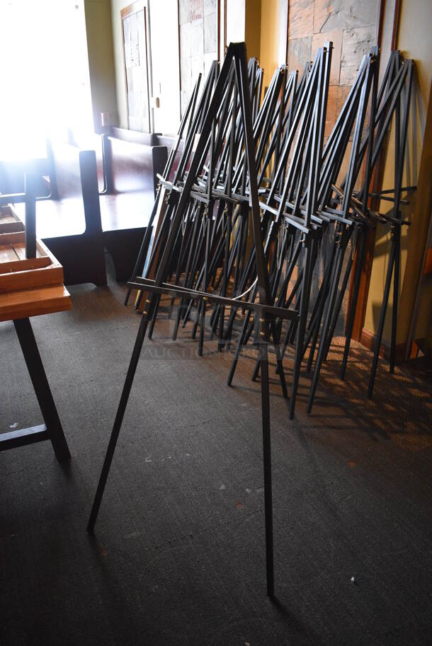 8 Black Easels. 1 BRAND NEW IN BOX. BUYER MUST REMOVE. 22x36x64. 8 Times Your Bid! (Susquehanna Ale House)