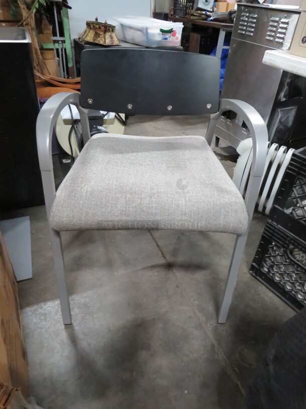 One NEW Modern Look Chair With A Silver Metal Frame, Wooden Back And Cushioned Seat. 
