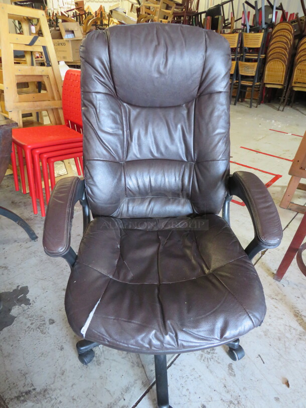 One Brown Pleather Office Chair On Casters. 