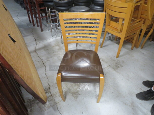 Wooden Chair In A Natural Finish With A Brown Cushioned Seat. 4XBID.