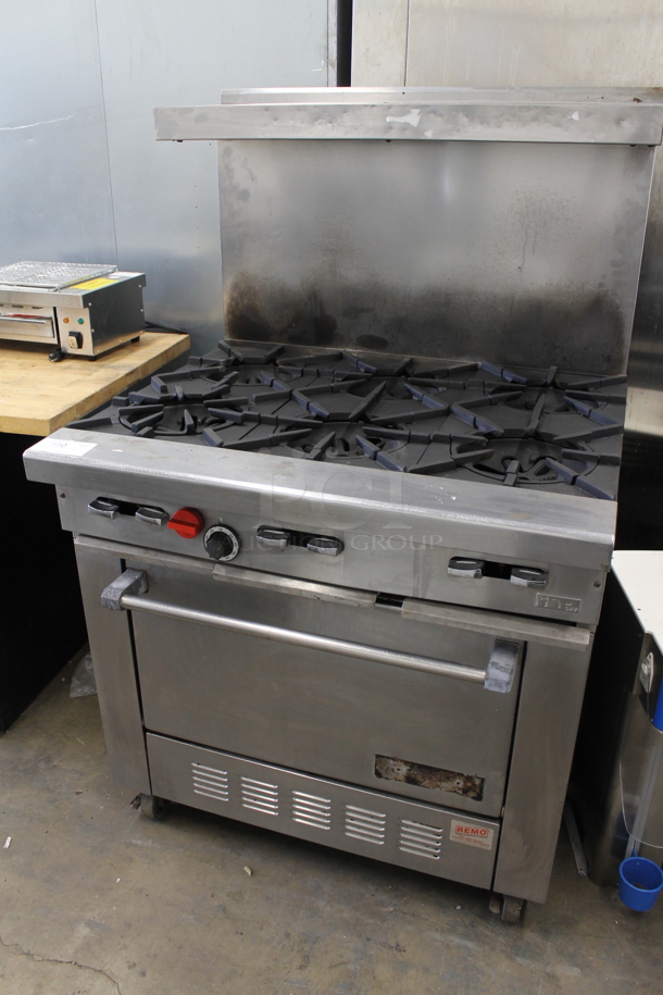 Garland H286 Stainless Steel Commercial Natural Gas Powered 6 Burner Range w/ Oven, Over Shelf and Back Splash on Commercial Casters.