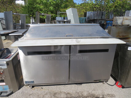 One Artic Air 2 Door Refrigerated Prep Table With 2 Racks, Cutting Board, On Casters. Model# AMT60R. 115 Volt. 62X36X46