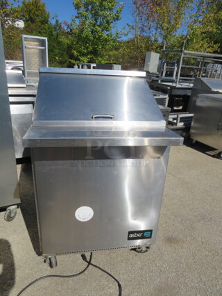 One ASber 1 Door Refrigerated Prep Table On Casters. Model# APTM27-12. 115 Volt. 27X34.5X46.5.