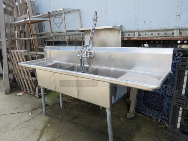 One Stainless Steel 3 Compartment Sink With R/L Drain Board, Back Splash, Faucet And Hose Sprayer. 1 Leg To Be Reattached. 90X24X45