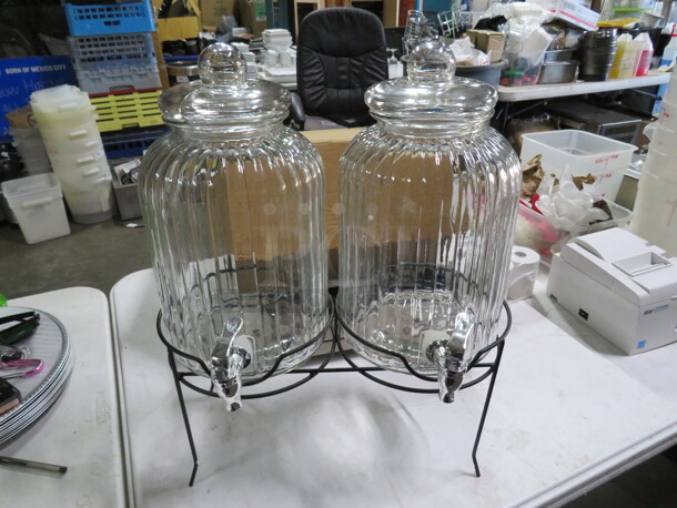 One Canyon Beverage Dispenser Set With Black Metal Stand ANd 2-1,3 Gallon Glass Dispensers. 1 Lid Cracked. See Pic. 