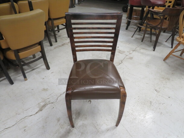 One Wooden Chair In A Dark Finish With A Brown Cushioned Seat. 