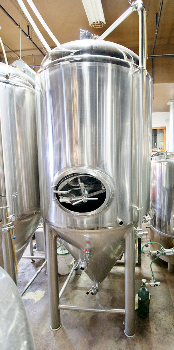 🍺 🍻 BEAUTIFUL!! Stout Tanks & Kettles - 15 BBL Fermenter / Unitank (Jacketed). 🍺 🍻 Features: Easily Converts to a Unitank or Brite Serving Tank; Glycol Jacketed - 2 Zones: Cone and Sidewall; Shadowless Manway for Easy Cleaning; Adjustable Racking Arm for Clear Transfer; 1.5" Sample Valve for Quality Testing; Back Mounted Pressure Gauge; Adjustable Feet for Leveling on Uneven Floors or Fine Height Adjustments; Pressure Gauge Type: Back Mount; CIP Arm and 2.5" Rotating CIP Spray Ball; 2 Butterfly Valves; Rated to 2-Bar (29 PSI); 1/2" NPT Welded Thermowell for Contactless Temperature Probe Tank Thickness: 3mm Jacket and Outer Shell Thickness: 2mm. Cone: 60 degree Interior Angle. 51.5-in. diameter x 125-in.H.