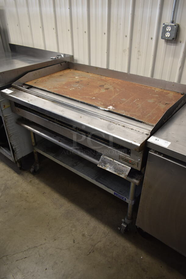 Thermatek TC48-48GN Stainless Steel Commercial Natural Gas Powered Flat Top Griddle on Stainless Steel Equipment Stand w/ Commercial Casters.