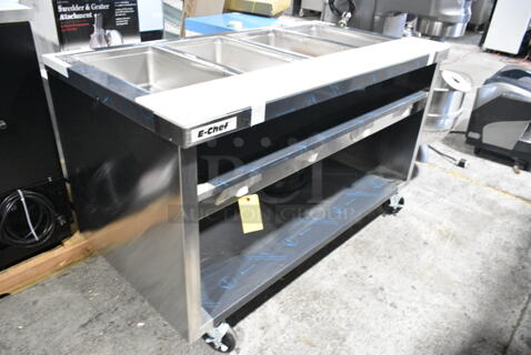 BRAND NEW SCRATCH AND DENT! 2023 Delfield EHEI60C Stainless Steel Commercial Floor Style Electric Powered 4 Bay Steam Table w/ Under Shelf on Commercial Casters. 208-230 Volts, 1 Phase. 