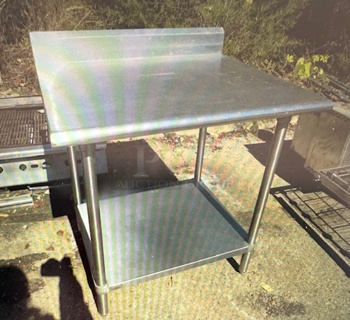 One Stainless Steel Table With Back Splash And SS Under Shelf. 36X30X40.5