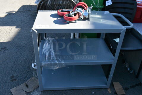 BRAND NEW SCRATCH AND DENT! Lavex Gray Metal 3 Tier Cart w/ Commercial Casters. 