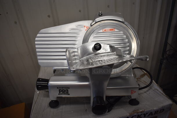 LIKE NEW! IN ORIGINAL BOX! Backyard Pro 554SL109E Stainless Steel Commercial Countertop Butcher Series 9" Manual Gravity Feed Meat Slicer w/ Sharpening Blade. 120 Volts, 1 Phase. 18x16x15. Tested and Working!