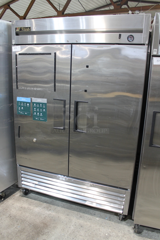 True T-49F Stainless Steel Commercial 2 Door Reach In Freezer w/ Poly Coated Racks on Commercial Casters. 115 Volts, 1 Phase. Tested and Working!