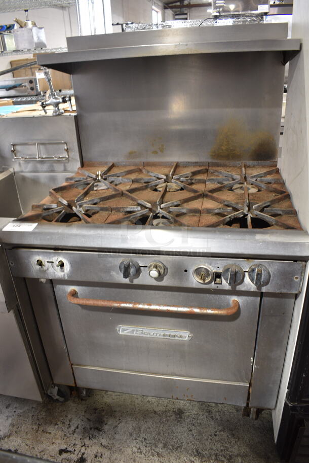 Southbend Stainless Steel Commercial Natural Gas Powered 6 Burner Range w/ Oven, Over Shelf and Back Splash on Commercial Casters. 