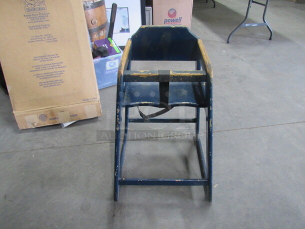One Blue Wooden High Chair With Safety Straps.