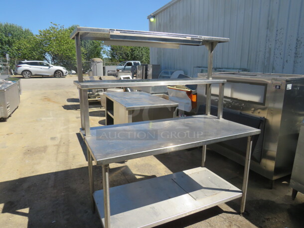 One Stainless Steel Table With A SS Under Shelf, 2 SS Over Shelves, And A 36 Inch Ticket Rail. 60X30X70