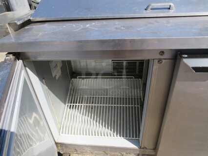 One Beverage Air 2 Door Refrigerated Prep Table With 1 Rack On Casters. Model# SPE-48-12. 115 Volt. 48X29X42