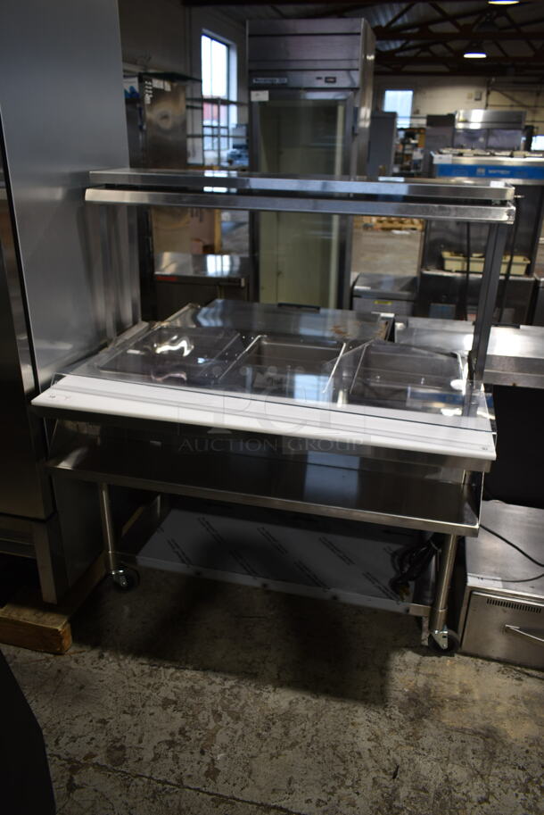 BRAND NEW SCRATCH AND DENT! Eagle SPHT3-120 Stainless Steel Commercial Floor Style 3 Bay Steam Table w/ Over Shelf and Under Shelf on Commercial Casters. 120 Volts, 1 Phase. Cannot Test Due To Plug Style