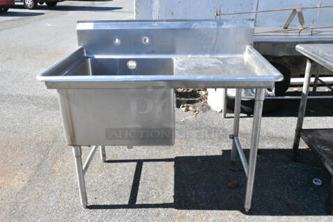 Stainless Steel Single Bay Sink w/ Right Side Drain Board. Bay 24x24x14. Drain Board 19x27. (out back)