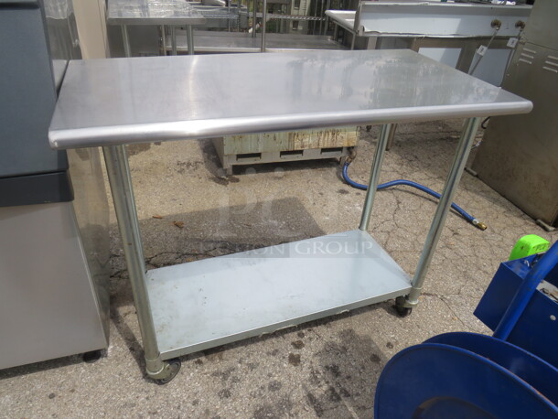 One Stainless Steel Table With Under Shelf On Casters. 48X24X38
