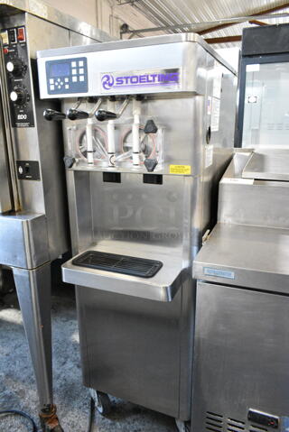 Stoelting F231-109I2YGAD1 Stainless Steel Commercial Floor Style Water Cooled 2 Flavor w/ Twist Soft Serve Ice Cream Machine on Commercial Casters. 208-240 Volts, 3 Phase.