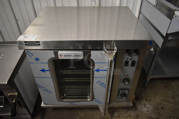 BRAND NEW SCRATCH AND DENT! 2022 Garland MCO-E-5-C Stainless Steel Commercial Electric Powered Half Size Convection Oven w/ View Through Door, Metal Oven Racks and Thermostatic Controls. 208 Volts, 3 Phase.