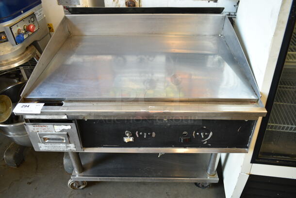 Stainless Steel Commercial Gas Powered Flat Top Griddle w/ Under Shelf on Commercial Casters. - Item #1117935