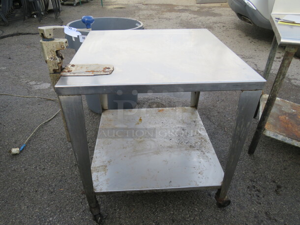 One Stainless Steel Table With Undershelf And 10lb Can opener On Casters. 27X27X30