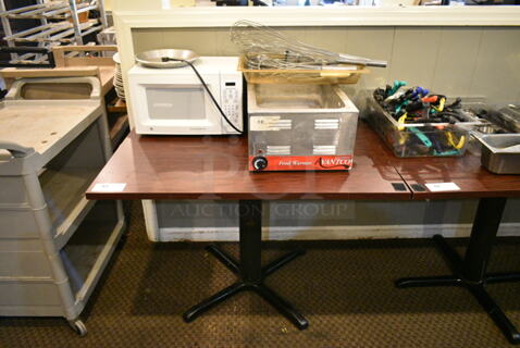 Wood Pattern Dining Height Table w/ Contents Including Avantco Food Warmer, General Electric Microwave, Utensils. (main dining room)