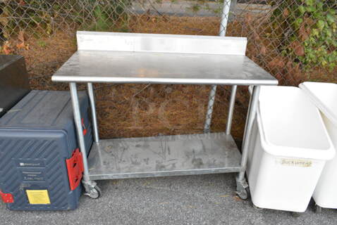 Stainless Steel Table w/ Back Splash and Under Shelf on Commercial Casters. 