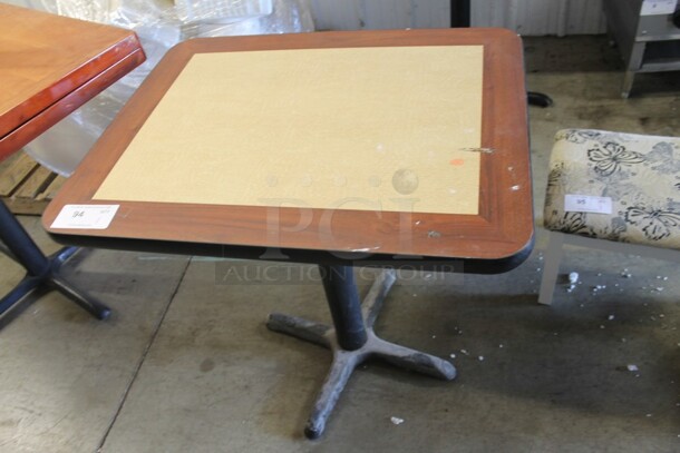 Wood Pattern and Tan Dining Height Table on Black Metal Table Base.