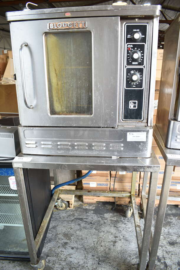 Blodgett Stainless Steel Commercial Natural Gas Powered Half Size Convection Oven w/ View Through Door, Metal Oven Racks, Thermostatic Controls and Equipment Stand on Commercial Casters. 