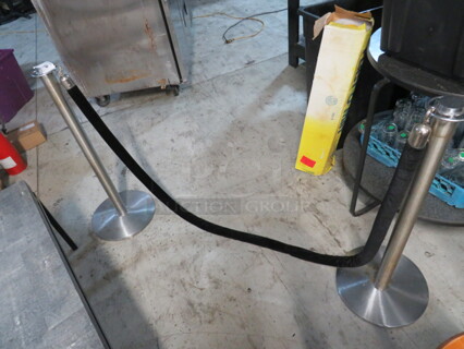 One Set Of 2 Crowd Control Poles With A Black Velvet Rope.