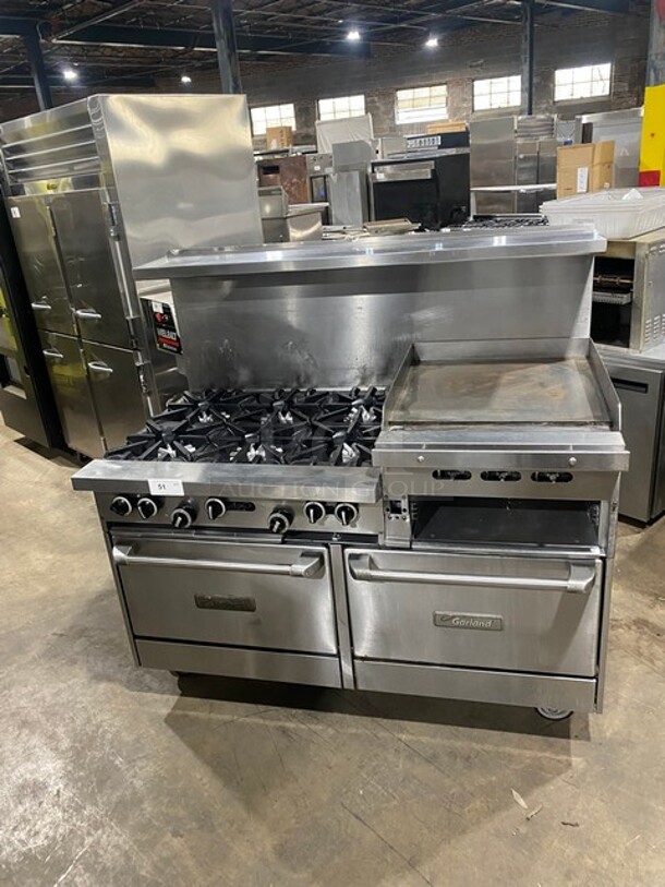 BEAUTIFUL! Garland Commercial Natural Gas Powered 6 Burner Stove With Raised Right Side Flat Griddle & Cheese Melter! Griddle Has Side Splashes! With Raised Back Splash And Salamander Shelf! With 2 Full Size Ovens Underneath! With Metal Oven Racks! All Stainless Steel! On Casters!